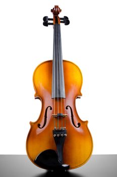 Violin on top of dark table ppartially isolated on white background.