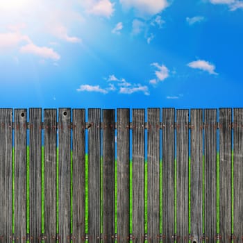 wooden fence against the blue sky