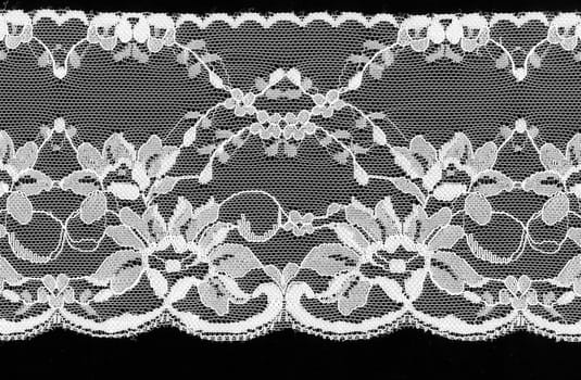 Beautiful  white floral lace on a black background.
