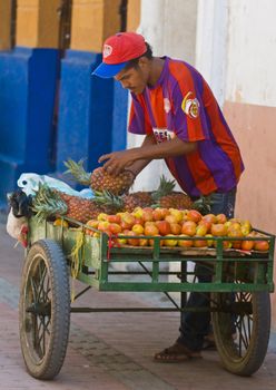 CARTAGENA DE INDIAS , COLOMBIA - DEC 20:Unidentified colombian man sell fruits in the street in Cartagena de Indias on December 20 2010