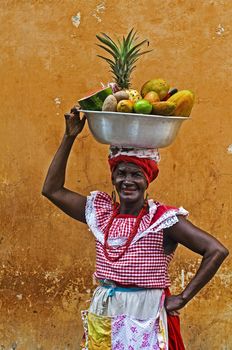 CARTAGENA DE INDIAS , COLOMBIA - DEC 21:Unidentified Palenquera woman sell fruts in Cartagena de Indias on December 21 2010,Palenqueras are  a unique African descendat ethnic group found in the north region of South America