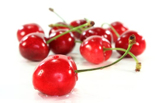 some red sweet cherries against white background
