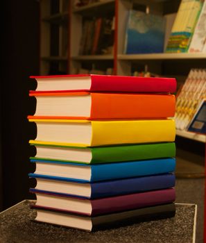 Pile of colorful books staying in the book shop