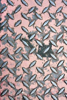 Close up of real worn diamond plate material with chipped paint.  