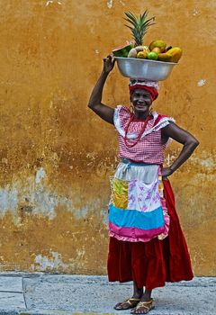 CARTAGENA DE INDIAS , COLOMBIA - DEC 21:Unidentified Palenquera woman sell fruts in Cartagena de Indias on December 21 2010,Palenqueras are  a unique African descendat ethnic group found in the north region of South America