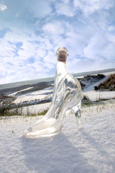 a crystal glass slipper in a snow covered irish golf course for a concept on ladies golf