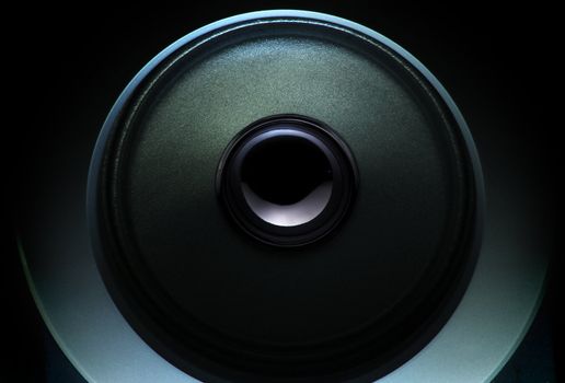 close up of a dark loudspeaker with light effect
