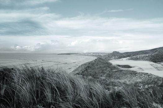 atlantic ocean beside a snow covered links golf course in ireland in snowy winter weather