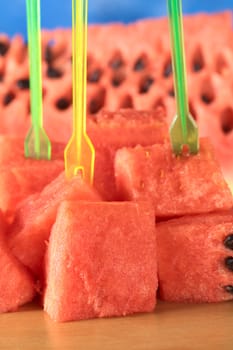 Fresh watermelon pieces with plastic skewers (Selective Focus, Focus on the front)  