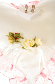 wedding ring on decorative pillow colored photo ** Note: Shallow depth of field