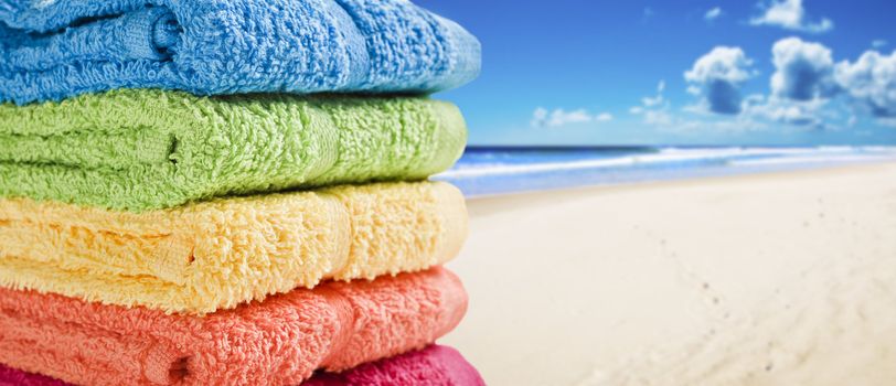 Colorful towels on a white beach on a summer day