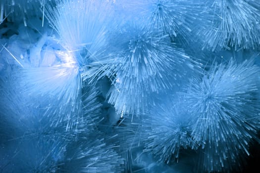 A background of blue crystallized forms in a cave.