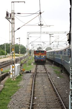A locomotive approaching a train on a railway track.
