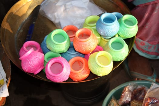 Colorful pots with religious designs for sale on the occassion of Diwali festival in India.