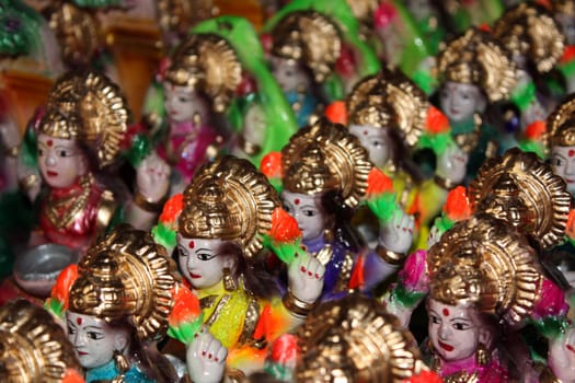 A background of small clay idols of hindu wealth goddess Laxmi.