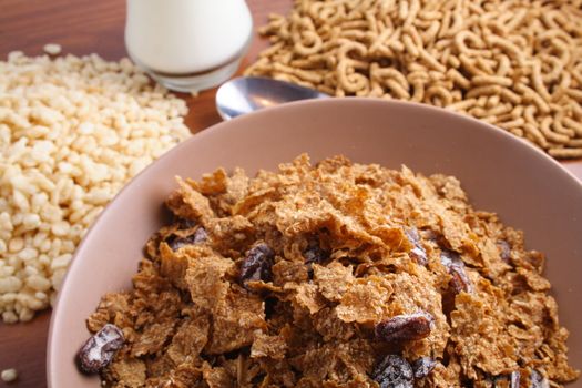 Bowl of cereal with milk and cereal in background