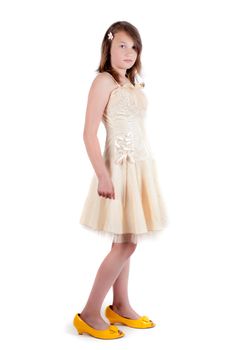 Teenager girl in mother's dress and shoes isolated on white