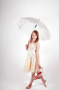 Teenager girl with white umbrella in studio