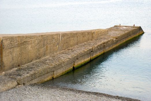 Breakwater on quay of the Crimean coast