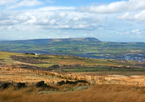 Moorland scene in Lancashire, north-east England, with Burnley town and Pendle Hill in the background