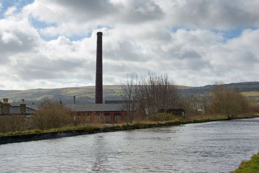 Old disused cotton spinning mill beside the canal in Burnley, Lancashire, England