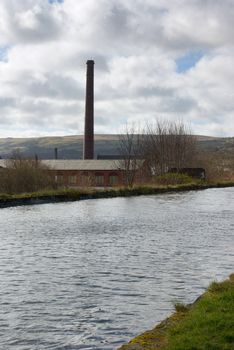 Old disused cotton spinning mill beside the canal in Burnley, Lancashire, England
