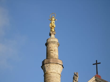 Minaret and church on a background of the sky