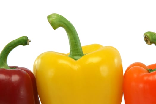 detail from three color peppers isolated on white background food and vegetables concepts