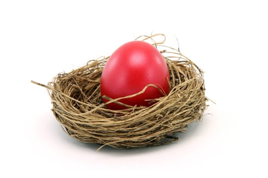 red easter egg in a nest isolated on white background seasonal