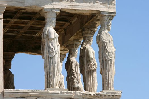 caryatids and blue sky  at temple of Erechtheum on acropolis of Athens Greece