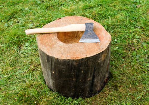 close-up on axe on wood log, rural view