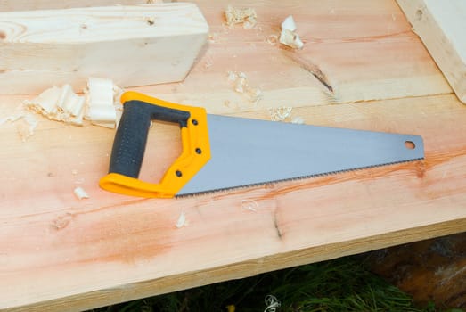 old hacksaw on wooden table