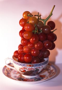 Grapes in china cup.