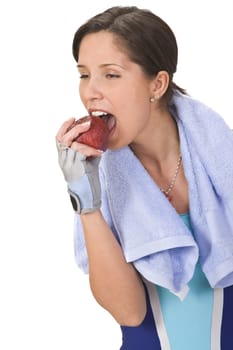 Young woman bitting a red apple.Shot with Canon 70-200mm f/2.8L IS USM