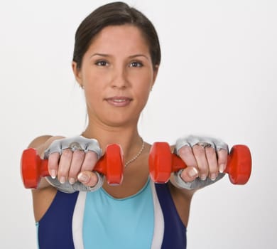 Image of a young woman doing barbells exercises,selective focus on the barbells.