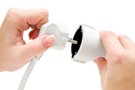 Woman connecting a white extension cable. Isolated on a white background.