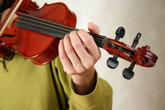 Musician playing violin close-up in studio