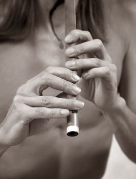 Hands of the musician playing on his wind instrument 