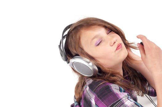 Teenager girl with headphones in studio isolated on white