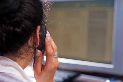 Secretary on the telephone in front of her computer