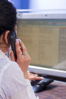 Secretary on the telephone in front of her computer