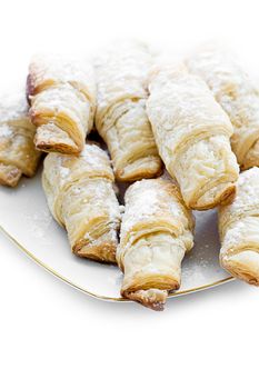 French small croissants with powdered sugar on plate