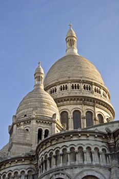 Basilica of Sacre Coeur in Paris. Against the blue clear sky. Urban scene.