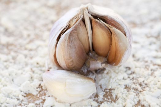 Bulb of fresh Italian garlic broken open exposing the cloves.