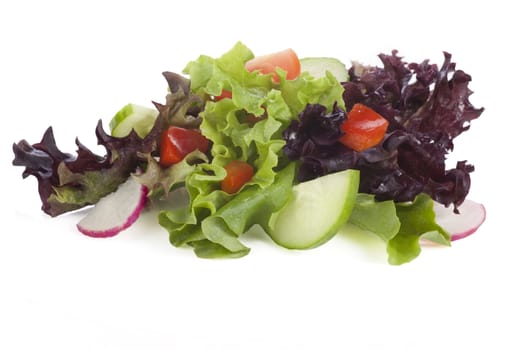 Fresh salad with lettuce greens, cucumber, radish and tomato isolated on a white background.