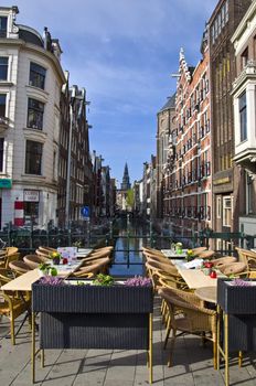 Outdoor terrace restaurant on the canal in Amsterdam. Urban scene