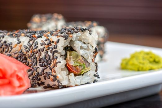 Closeup of Sushi rolls at plate with sesame
