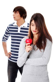 Young couple with red heart. Isolated on white background.