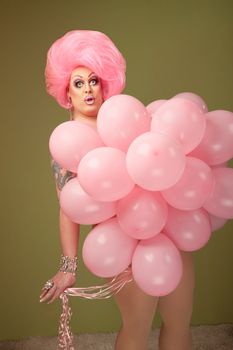 Large woman with pink balloons on green background