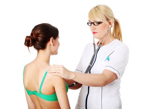 Mature female doctor examining with female patient.